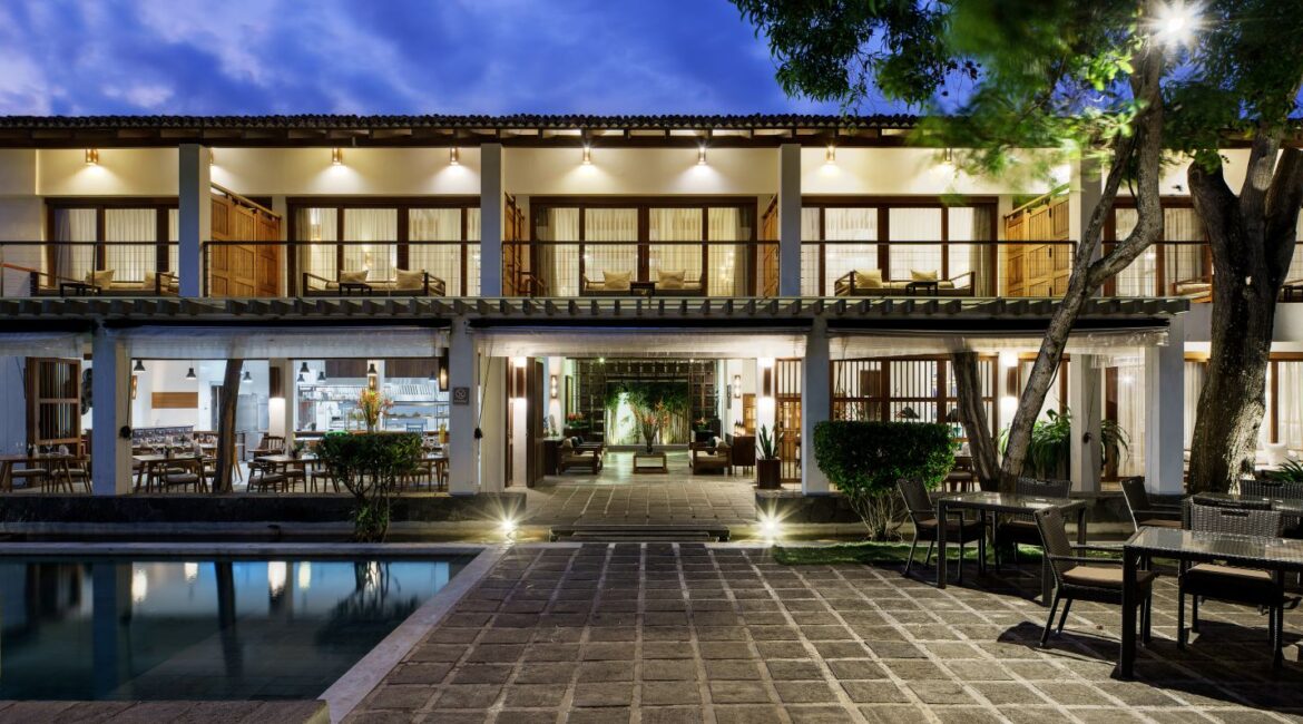 Lantern Boutique Hotel on Sri Lanka’s South Coast – dusk view of the ocean-facing terrace with soft lighting, swimming pool, and alfresco dining near Mirissa