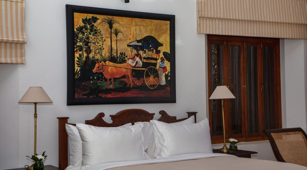 Landesi Galle Fort Sri Lanka Deluxe Room downstairs beuatiful bed and bright white washed walls and dark wood fixtures