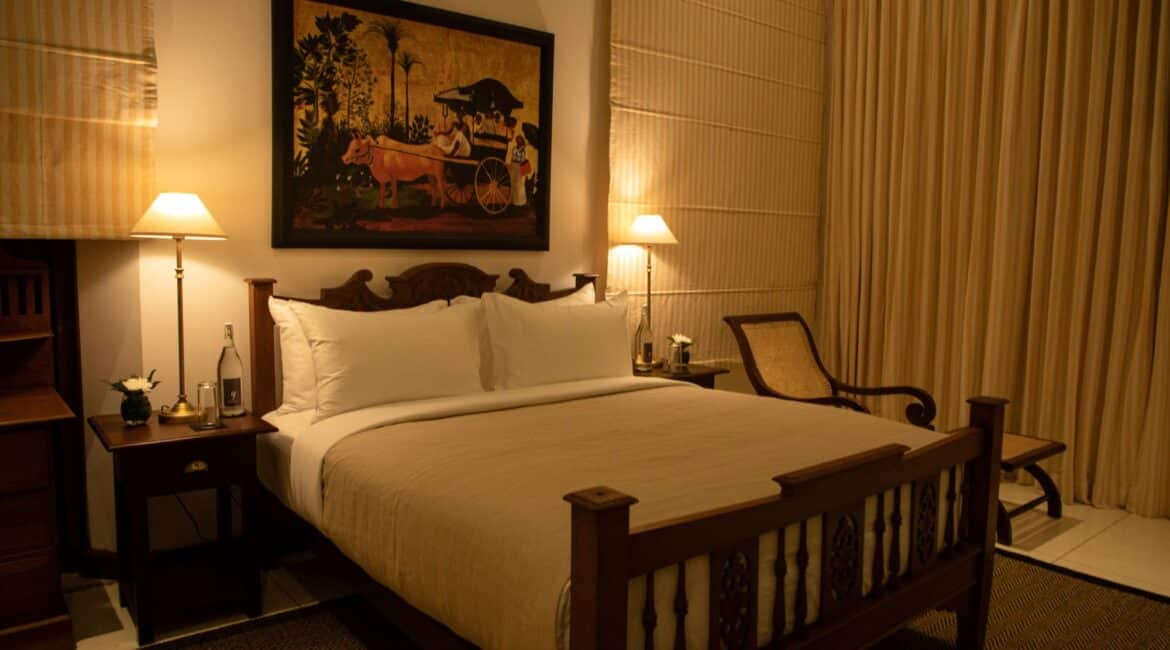 Landesi Galle Fort Sri Lanka Deluxe Room downstairs stunning bedroom by night with mellow lighting