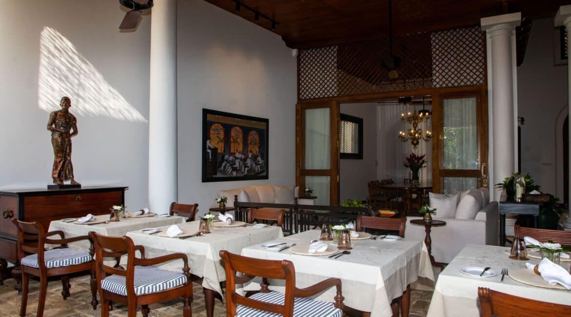 Charming outdoor dining setting at Landesi Galle Fort, with a comfortable lounge area behind