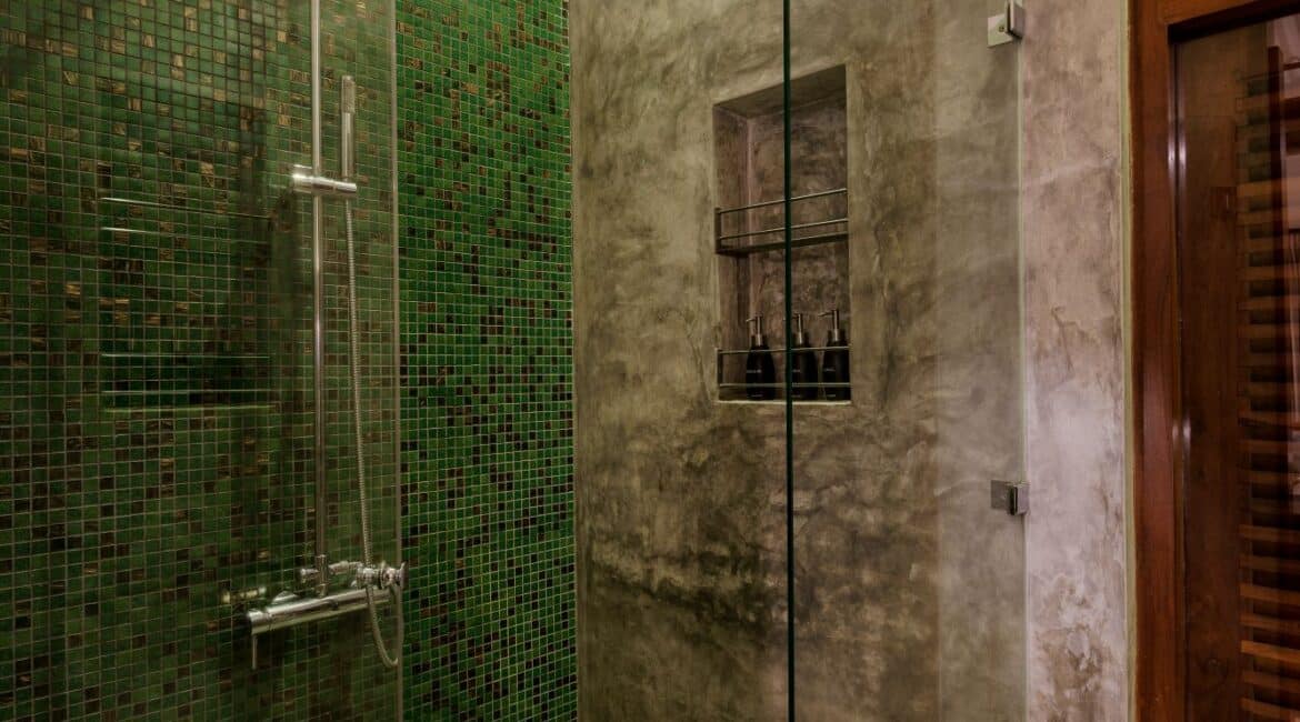 Ocean Suite at Lantern Boutique Hotel Sri Lanka – en suite bathroom with rainfall shower, WC, and stylish green tiling