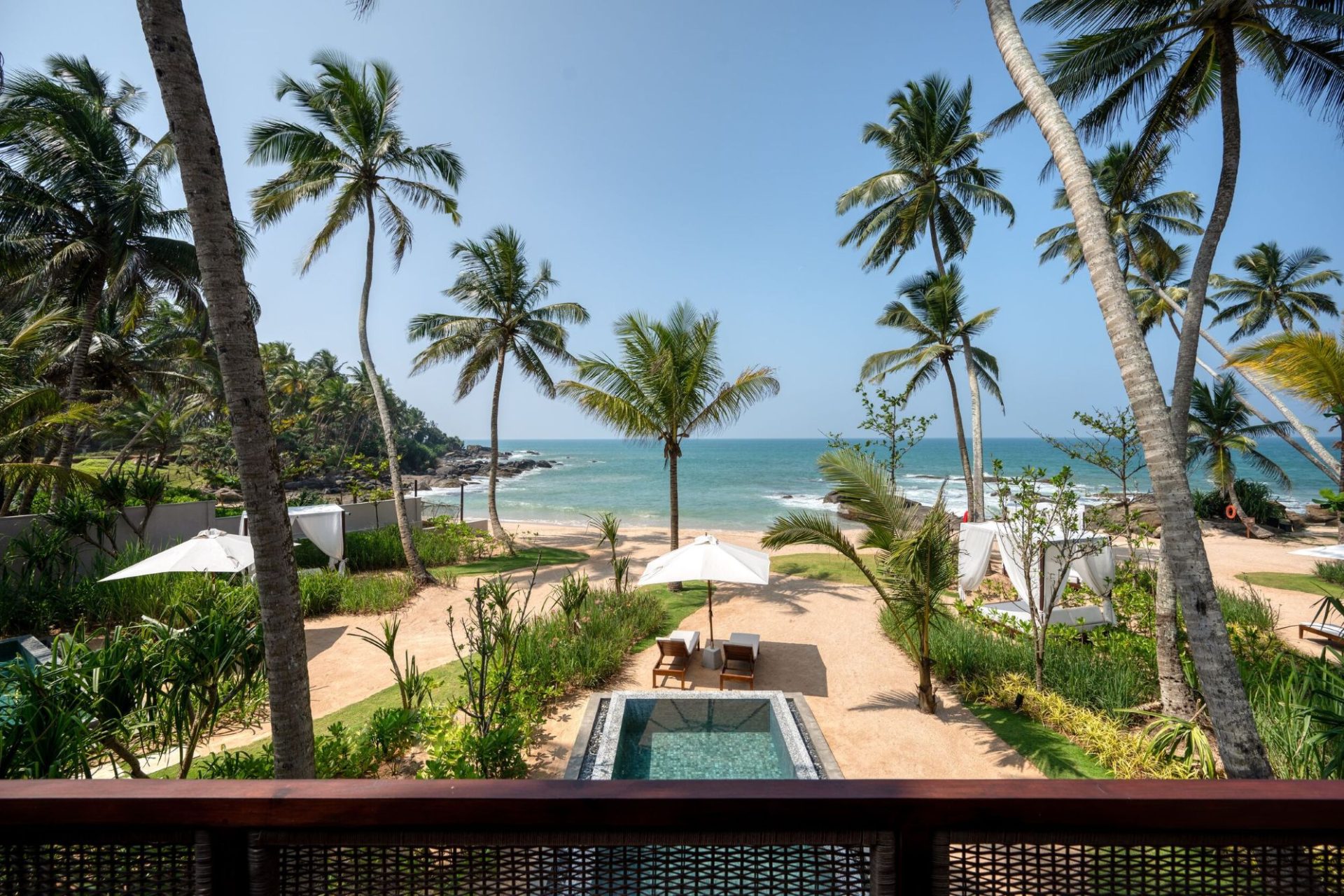 Gorgeous beach at Ahu Bay Sri Lanka with golden sand, palm trees, and gentle waves creating a tranquil coastal atmosphere.