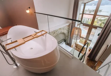 Boho Garden Hotel Loft Room with bath tub and staircase to bath