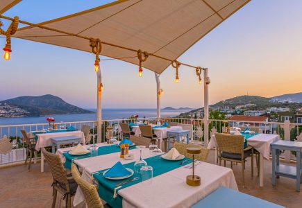 omantic rooftop dining at the Oasis Hotel in Kalkan, with sea views and a candlelit table for two
